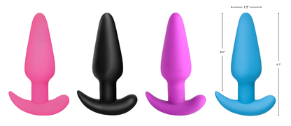  A selection of colorful silicone butt plugs (pink, blue, purple, black), with a remote control displayed in the center.