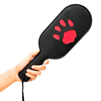 Puppy paddle with paw print imprint, available in red or black. Perfect for BDSM impact play and pup play enthusiasts. Keywords: puppy paddle, BDSM impact play paddle, paw print paddle, pup play gear, Prowler RED paddle, red paw print paddle, black paw print paddle, BDSM accessories, pup play fetish paddle, durable impact paddle, beginner-friendly BDSM gear.