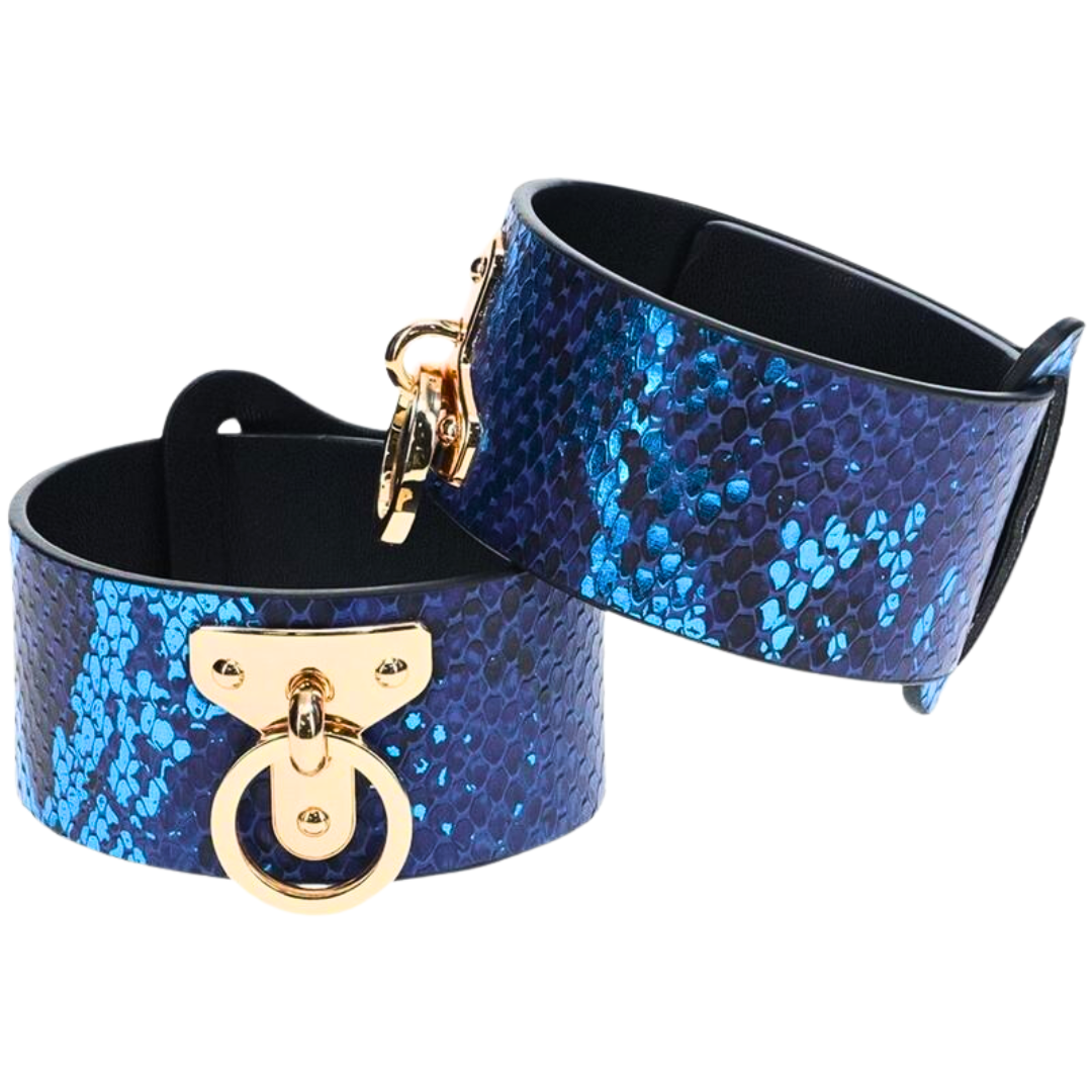 The Florence Iridescent Snake BDSM Ankle Cuffs by Ouch! feature bonded leather, gold-tone hardware, and adjustable straps for stylish and functional restraint.