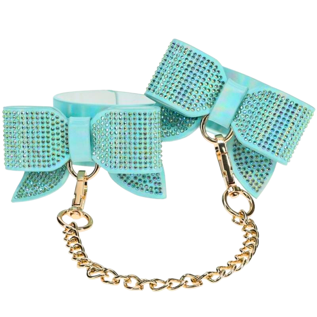 Adjustable handcuffs with rhinestone bows and a gold chain leash, available in black, pink, and blue for stylish and playful BDSM use.