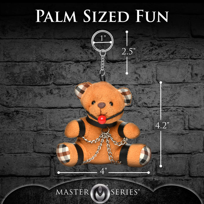 Burnt orange teddy bear keychain with cuffs, chains, and a ball gag, perfect as a gag gift or fun accessory.

gagged teddy bear keychain, BDSM bear keychain, gag gift kinky bear, bondage bear accessory, gagged teddy bag charm, quirky gag gifts, BDSM flagging keychain, teddy bear bondage toy, kinky novelty bear, bondage-themed accessories