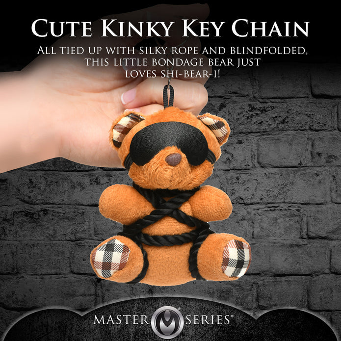 Burnt orange teddy bear keychain tied in silky rope bondage with a removable blindfold, a fun novelty accessory or gift.

shibari teddy bear keychain, rope bondage bear keychain, BDSM novelty gift, bondage bear keychain accessory, kinky teddy bear gift, burnt orange bear keychain, shibari rope bear, playful bondage bear keychain, BDSM-themed keychain gift, novelty shibari bear accessory