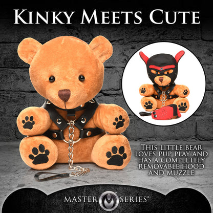 Light peach bondage teddy bear with faux leather harness, mini flogger, and removable eye mask—playful and cuddly with a BDSM aesthetic.

