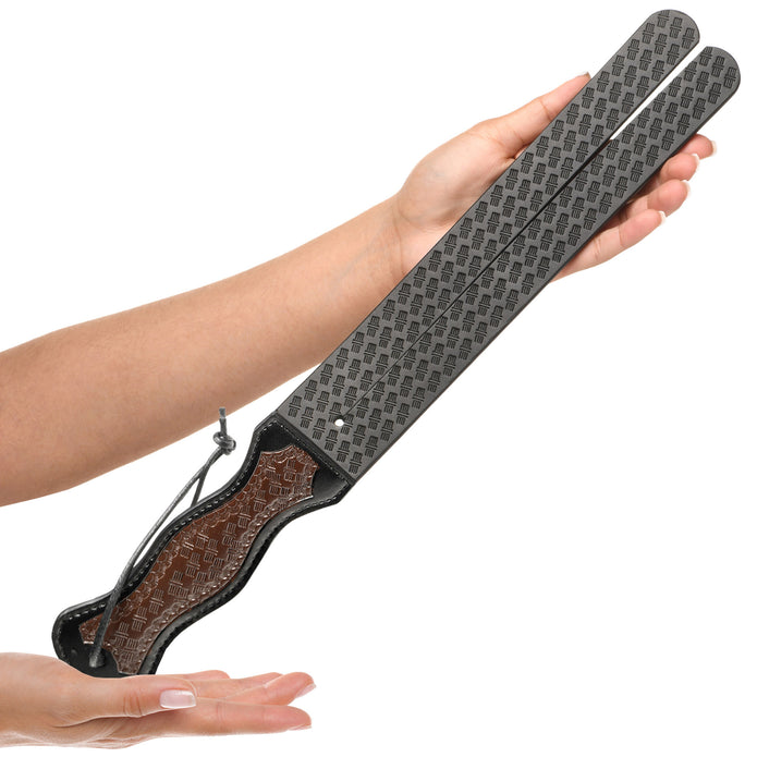 Black-and-brown vegan leather tawse whip with split ends and a curved handle, designed for stylish and functional BDSM impact play.