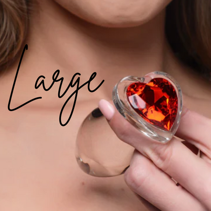 Clear glass anal plug with a red heart-shaped base, available in Small, Medium, or Large, designed for temperature play and smooth, comfortable insertion.

Booty Sparks red heart plug, glass anal plug, heart-shaped anal plug, temperature play anal plug, small glass anal plug, medium glass anal plug, large glass anal plug, red heart butt plug, hypoallergenic anal toy, romantic anal toy