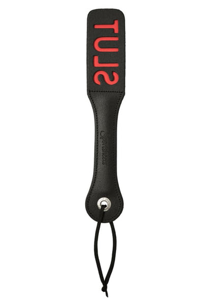 Leather paddle with "SLUT" cut-out, designed to imprint the word during impact play.

