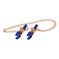 Gold chain nipple clamps with blue tips, adjustable thumb-screws, and removable rubber tips for varied intensity and versatile sensation play