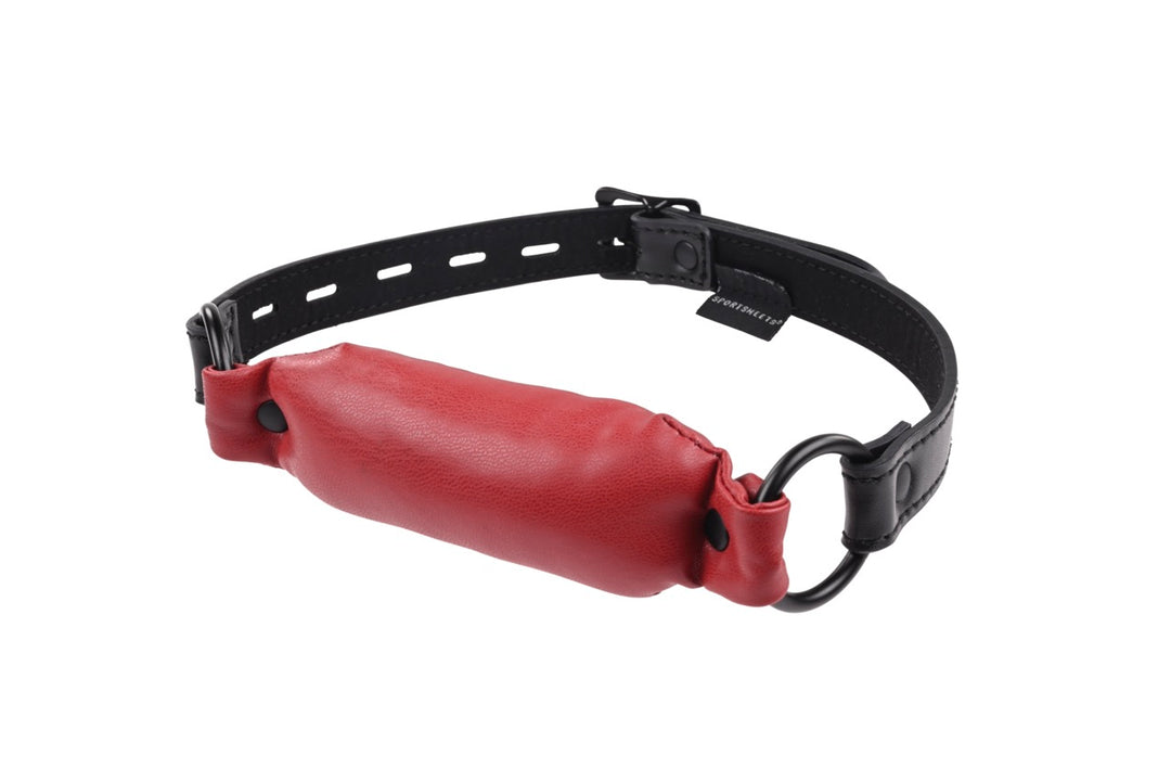 Saffron Soft Bit Gag in red vegan leather with an adjustable buckle, perfect for bondage play. Keywords: Saffron Soft Bit Gag, vegan leather bit gag, red gag for bondage, Sportsheets gag, comfortable bit gag, adjustable bondage gag, BDSM gag, kink accessories, bondage restraints, gags and muzzles.