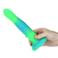 Glow-in-the-dark silicone dildos in vibrant blue, pink, and green colors with a bendable design and strong suction base. Keywords: glow-in-the-dark dildo, bendable silicone dong, vibrant sex toys, strong suction base dildo, harness-compatible toys, premium silicone dildos, rave-themed adult toys, colorful sex toys, party-themed dildos, bonus PowerBullet included.