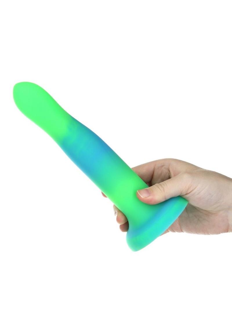 Glow-in-the-dark silicone dildos in vibrant blue, pink, and green colors with a bendable design and strong suction base. Keywords: glow-in-the-dark dildo, bendable silicone dong, vibrant sex toys, strong suction base dildo, harness-compatible toys, premium silicone dildos, rave-themed adult toys, colorful sex toys, party-themed dildos, bonus PowerBullet included.