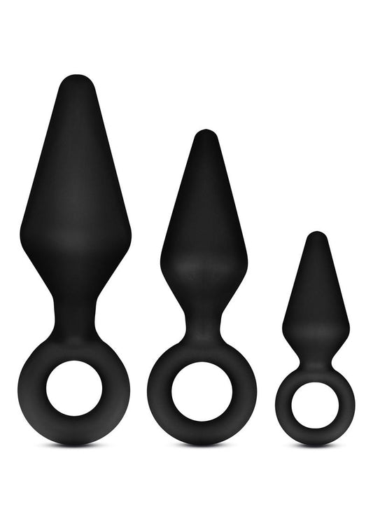 Anal Adventures Platinum Silicone Loop Plug Kit - Black - Set Of 3 A product image of the Anal Adventures Platinum Silicone Loop Plug Kit by Blush Novelties. The packaging displays three black tapered plugs with loop bases in small, medium, and large sizes, made from 100% silicone with a smooth finish.