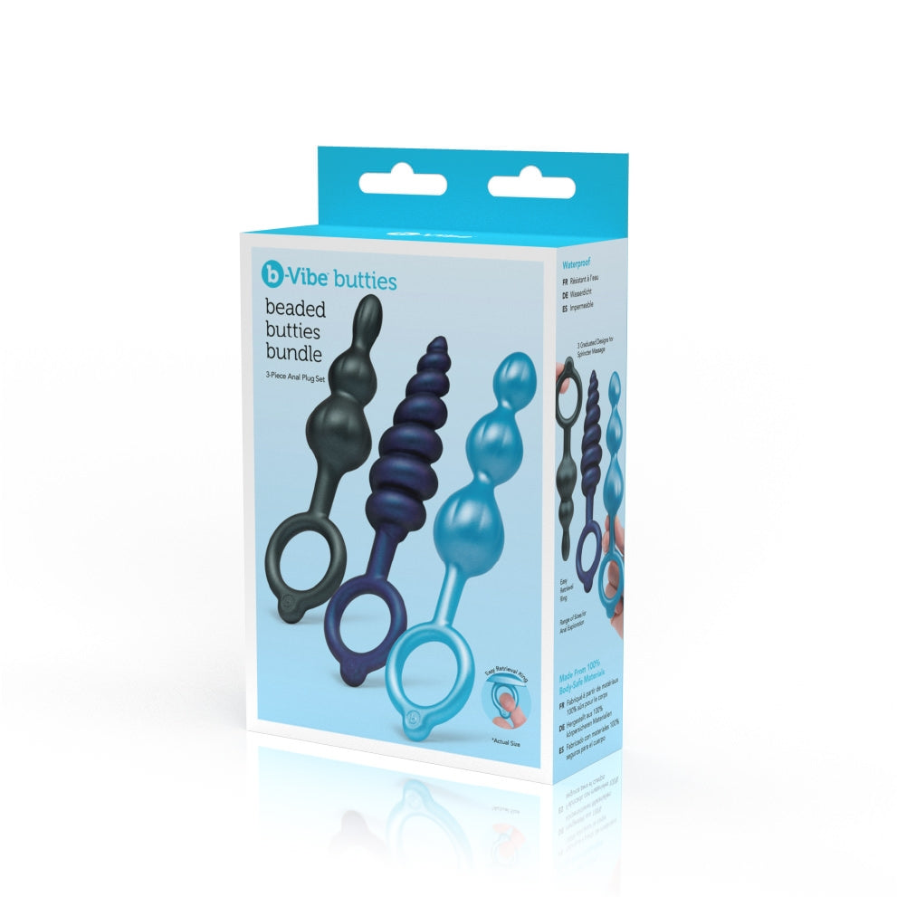 A set of three graduated silicone anal plugs in varying textures and sizes, featuring smooth, beaded designs in black, blue, and metallic purple. Each plug has a retrieval ring for easy handling and removal, and the plugs are displayed upright to highlight their unique shapes.