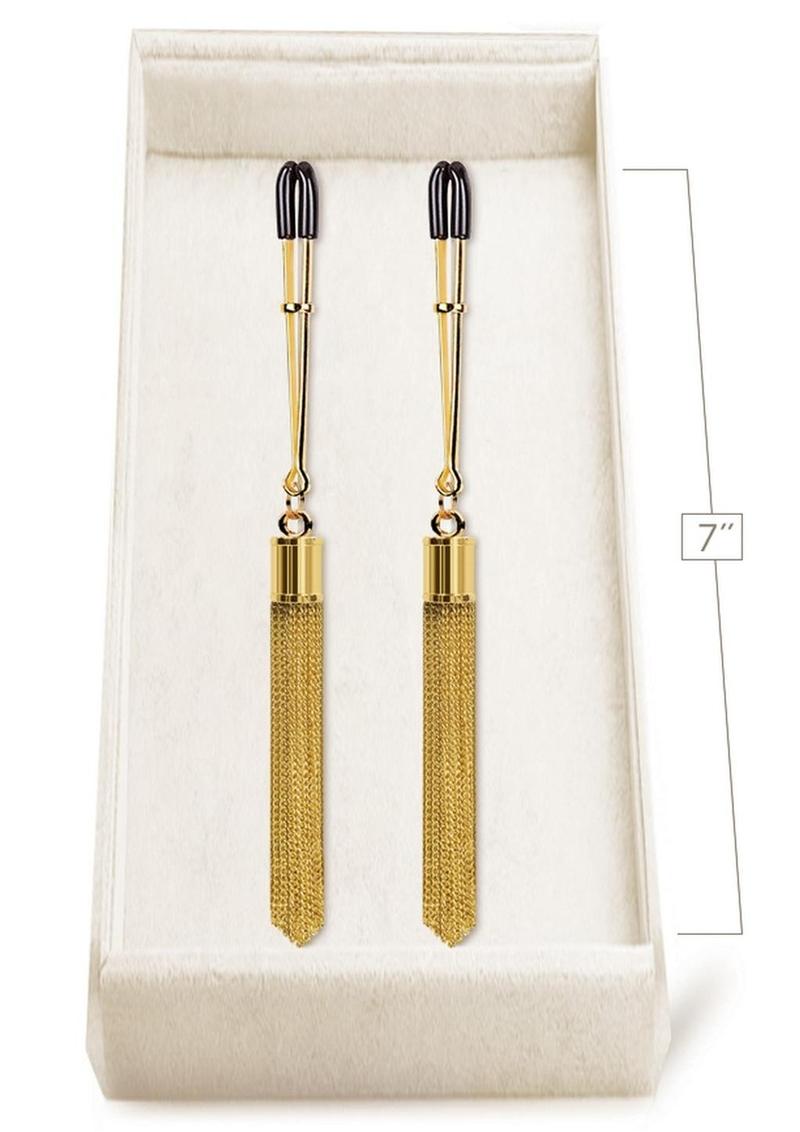 Luxury golden nipple clamps with tassels by Studio Elysee, lightweight and adjustable for sensual play. Keywords: luxury nipple clamps, golden nipple clamps, chic nipple clamps, Parisian nipple jewelry, adjustable nipple clamps, nipple play accessories, glamorous nipple clamps, Studio Elysee clamps, lightweight nipple clamps, elegant nipple accessories.