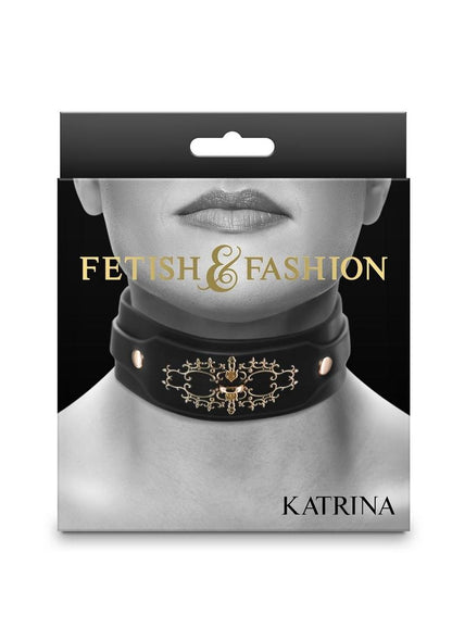 Black collar with intricate golden embellishments, adjustable buckle closure, and a D-ring, crafted from PU leather and nickel-free hardware, designed for neck sizes 11.5 to 16.5 inches. Keywords: Katrina Collar, golden embellishments, BDSM collar, D-ring collar, royal-inspired collar, adjustable fit, PU leather, nickel-free hardware, elegant day collar, luxury fetish collar, leash compatible, Fetish & Fashion, regal BDSM accessories.