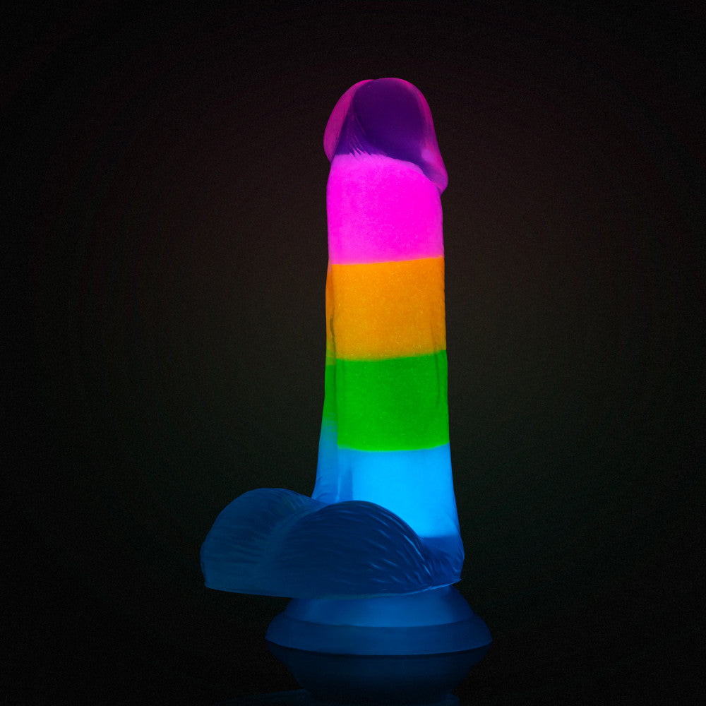 A vibrant glow-in-the-dark rainbow dildo with dual-density silicone, a suction cup base, and lifelike details. Perfect for hands-free or strap-on play. Keywords: Neo Elite Rainbow Rave, glow-in-the-dark dildo, rainbow dildo, Sensa Feel, dual-density silicone, Purio silicone, harness-compatible dildo, suction cup dildo, body-safe silicone, lifelike dildo, beginner-friendly toy 