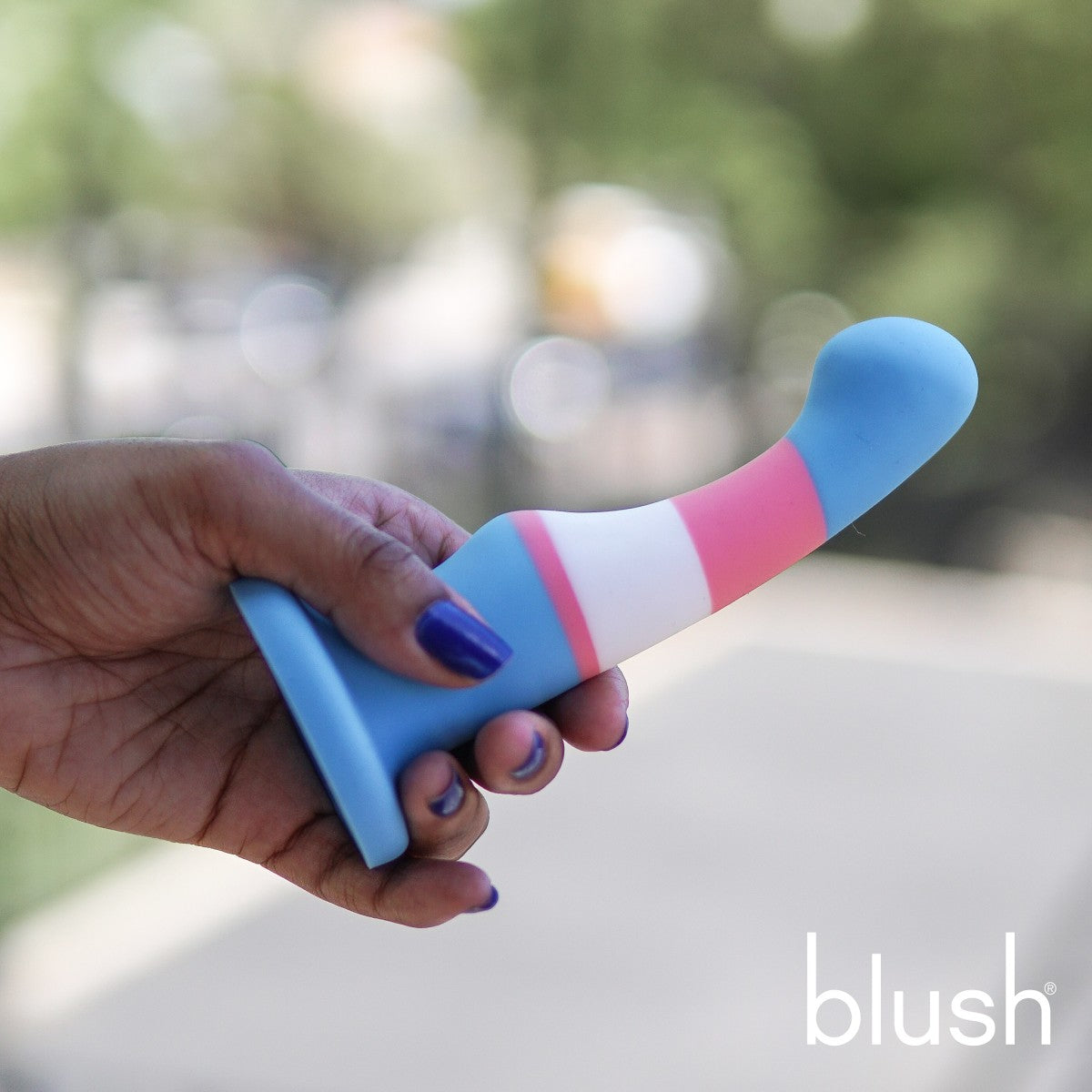 Trans pride flag-colored silicone dildo with a curved shaft, suction base, and smooth finish for G-spot or P-spot stimulation. Keywords: trans pride dildo, Avant dildo, G-spot dildo, P-spot dildo, suction cup dildo, harness-compatible dildo, body-safe silicone dildo, Purio silicone, colorful pride dildo, artisan-crafted dildo.