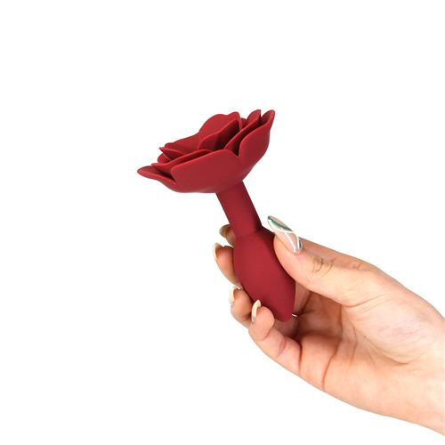 Red silicone anal plug with a rose-shaped base and a sleek, tapered design, perfect for elegant and pleasurable exploration. Keywords: rose anal plug, LUX active Red Rose, silicone anal plug, elegant anal toy, vibrating anal plug, PowerBullet anal plug, body-safe anal toy, tapered anal plug, flexible silicone plug, waterproof anal plug.