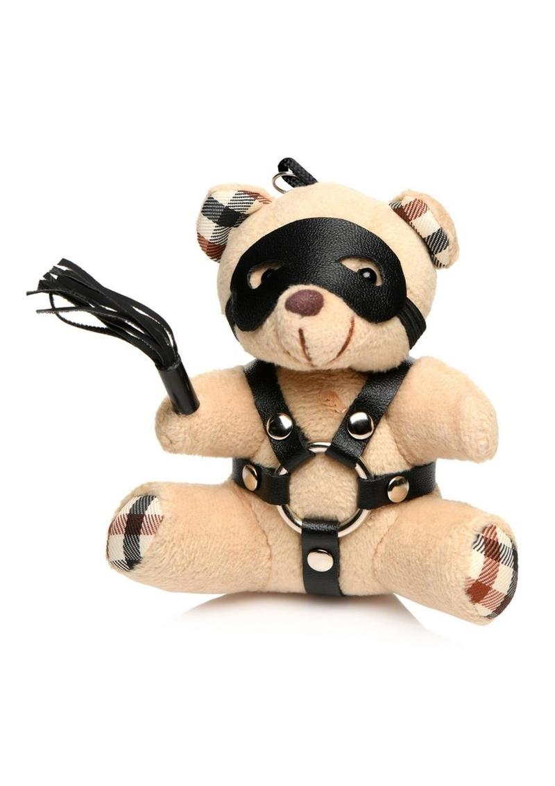 Mini bondage bear with harness, flogger, and removable eye mask for kinky gifting or accessories.

bondage bear keychain, BDSM novelty gift, bondage bear accessory, kinky keychain gift, leather harness bear, mini BDSM bear, bondage-themed gifts, faux leather keychain bear, bondage novelty toys, BDSM flagging accessory