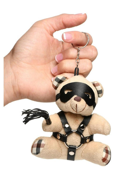 Mini bondage bear with harness, flogger, and removable eye mask for kinky gifting or accessories.

bondage bear keychain, BDSM novelty gift, bondage bear accessory, kinky keychain gift, leather harness bear, mini BDSM bear, bondage-themed gifts, faux leather keychain bear, bondage novelty toys, BDSM flagging accessory