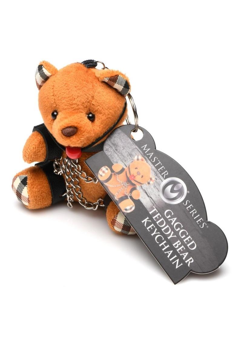 Burnt orange teddy bear keychain with cuffs, chains, and a ball gag, perfect as a gag gift or fun accessory.

gagged teddy bear keychain, BDSM bear keychain, gag gift kinky bear, bondage bear accessory, gagged teddy bag charm, quirky gag gifts, BDSM flagging keychain, teddy bear bondage toy, kinky novelty bear, bondage-themed accessories