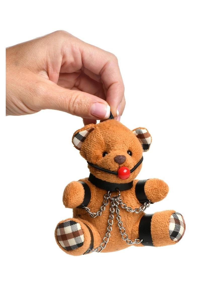 Burnt orange teddy bear keychain with cuffs, chains, and a ball gag, perfect as a gag gift or fun accessory.

gagged teddy bear keychain, BDSM bear keychain, gag gift kinky bear, bondage bear accessory, gagged teddy bag charm, quirky gag gifts, BDSM flagging keychain, teddy bear bondage toy, kinky novelty bear, bondage-themed accessories