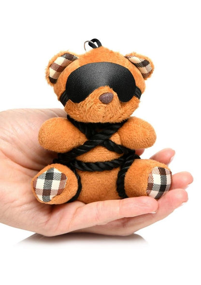 Burnt orange teddy bear keychain tied in silky rope bondage with a removable blindfold, a fun novelty accessory or gift.

shibari teddy bear keychain, rope bondage bear keychain, BDSM novelty gift, bondage bear keychain accessory, kinky teddy bear gift, burnt orange bear keychain, shibari rope bear, playful bondage bear keychain, BDSM-themed keychain gift, novelty shibari bear accessory