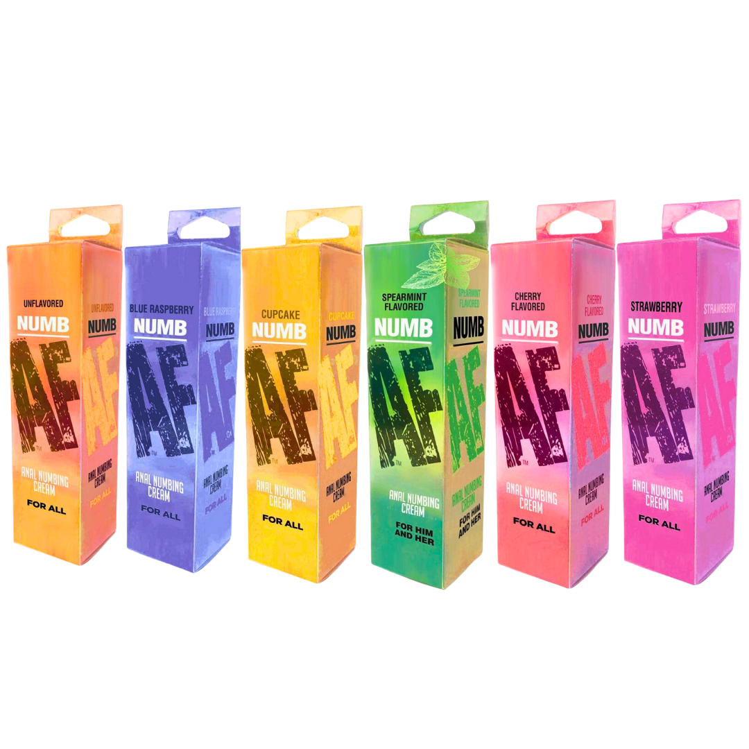 A lineup of six colorful boxes of NUMB AF Anal Numbing Cream, each in a different flavor and color. From left to right, the flavors include Unflavored (orange box), Blue Raspberry (blue box), Cupcake (yellow box), Spearmint (green box), Cherry (peach box), and Strawberry (pink box). Each box displays "NUMB AF" prominently in large, bold text, with "Anal Numbing Cream" and "For All" below. The packaging highlights the product's variety of flavors, designed for comfort and ease during anal play.