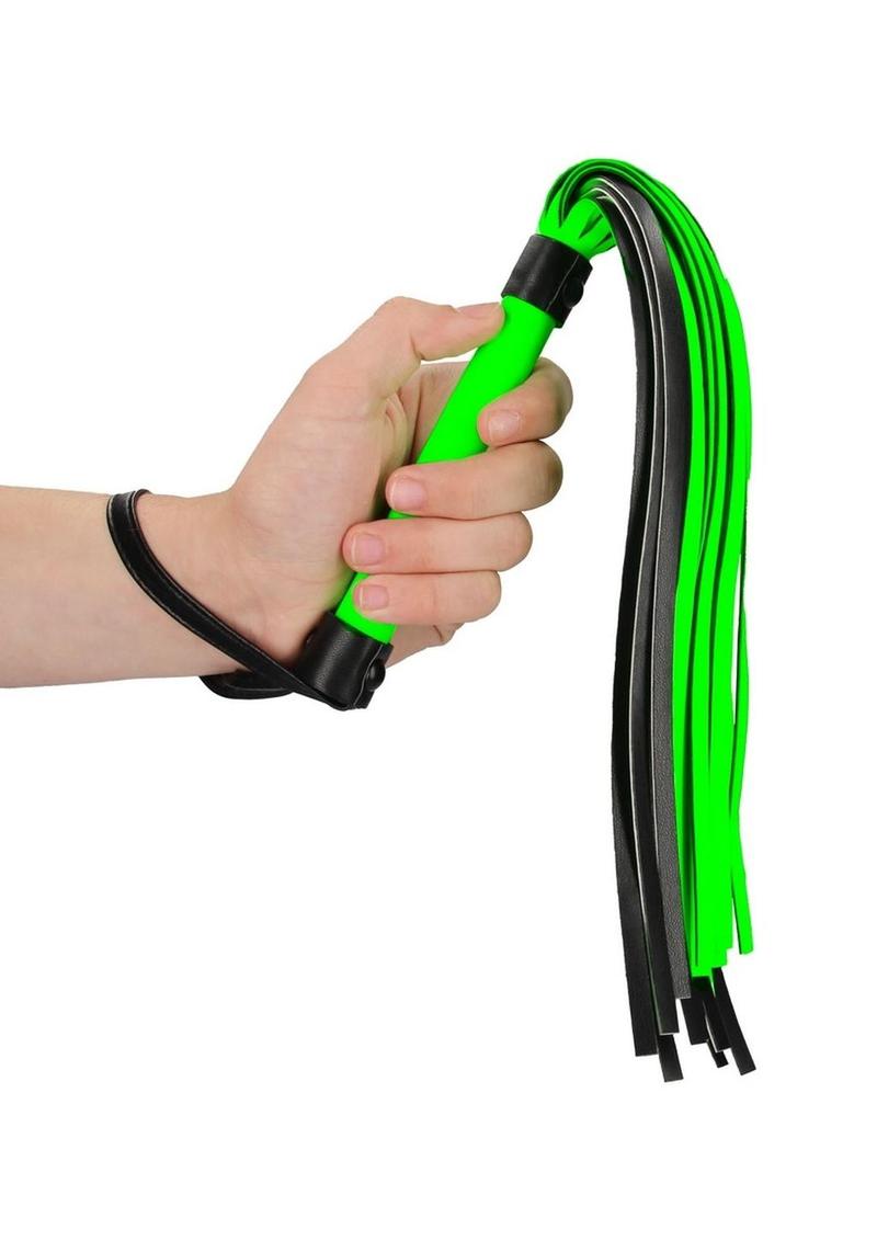 Ouch! Flogger - Black/Glow In The Dark/Green Glow-in-the-dark BDSM flogger with a sturdy handle and fluorescent green detailing. Keywords: Ouch Glow in the Dark BDSM Flogger, glow-in-the-dark flogger, fluorescent green BDSM whip, glow bondage gear, beginner BDSM flogger, glow-in-the-dark fetish whip, BDSM impact toy, neon bondage flogger, BDSM glow gear, flogger for kinky play.