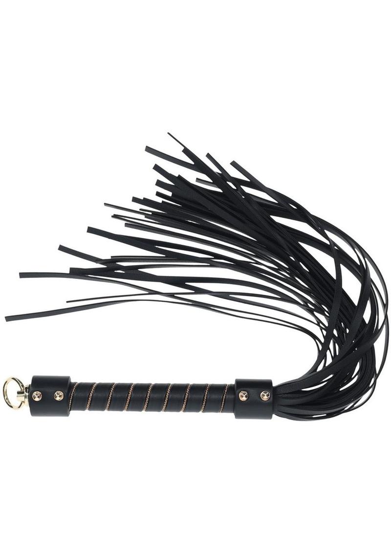 a black flogger, a BDSM accessory designed for impact play. The handle is sturdy and wrapped in black material with gold accents, offering a secure grip. The flogger features multiple soft leather strands, making it suitable for a range of sensations, from light teasing to more intense impact. At the base of the handle, there is a metallic loop for hanging or easy storage. The overall design is sleek and elegant, combining functionality with a stylish aesthetic. London Collection Flogger by Ouch! featuring 