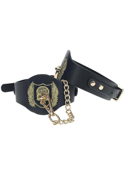 London Collection Ankle Cuffs by Ouch! featuring black bonded leather, gold skull and wings embroidery, and iridescent gold hardware for stylish BDSM play