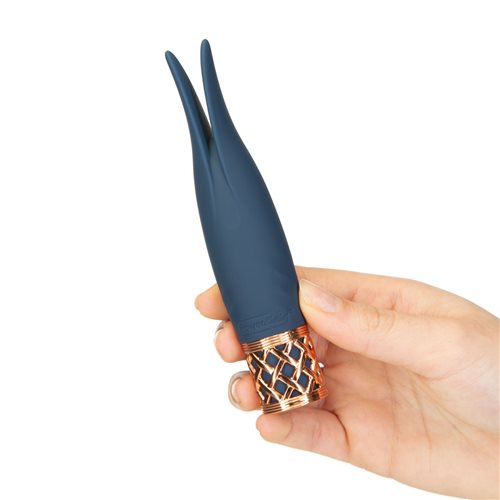 Mini navy blue wand vibrator with flickering rabbit ear tips, a rose gold lattice base, and incremental speed control for targeted stimulation.
Keywords: rabbit ear vibrator, mini wand massager, Pillow Talk Secrets, PowerBullet motor, silicone vibrator, clitoral vibrator, travel-friendly vibrator, waterproof mini vibrator, rechargeable vibrator, rose gold vibrator.