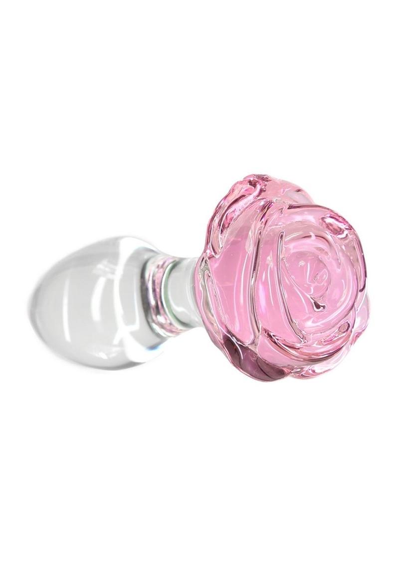 Pillow Talk Rosy Glass Anal Plug - Clear/Pink Pink rose-shaped glass anal plug with a tapered stem and elegant base for temperature play and luxurious anal stimulation. Keywords: glass anal plug, pink rose anal plug, luxurious anal toy, borosilicate glass plug, elegant anal stimulation, temperature play toy, beginner-friendly anal plug, body-safe anal plug, easy-to-clean glass toy, PowerBullet anal plug.