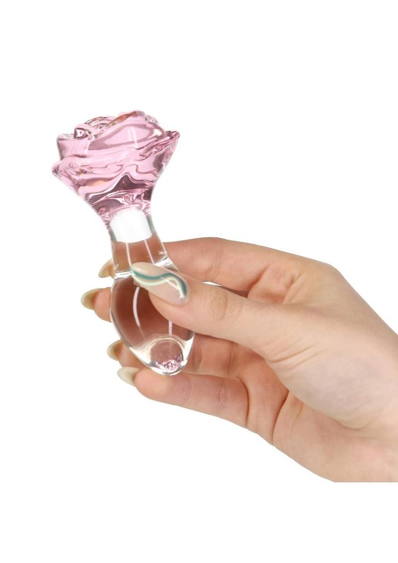 Pink rose-shaped glass anal plug with a tapered stem and elegant base for temperature play and luxurious anal stimulation. Keywords: glass anal plug, pink rose anal plug, luxurious anal toy, borosilicate glass plug, elegant anal stimulation, temperature play toy, beginner-friendly anal plug, body-safe anal plug, easy-to-clean glass toy, PowerBullet anal plug.