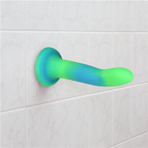 Glow-in-the-dark silicone dildos in vibrant blue, pink, and green colors with a bendable design and strong suction base. Keywords: glow-in-the-dark dildo, bendable silicone dong, vibrant sex toys, strong suction base dildo, harness-compatible toys, premium silicone dildos, rave-themed adult toys, colorful sex toys, party-themed dildos, bonus PowerBullet included.