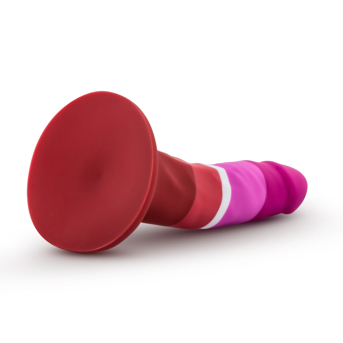 Lesbian pride-colored silicone dildo with a petite design, straight shaft, and suction base, made from smooth Purio™ silicone. Keywords: lesbian pride dildo, Avant dildo, petite dildo, beginner-friendly dildo, suction cup dildo, harness-compatible dildo, body-safe silicone dildo, colorful pride dildo, Purio silicone, artisan-crafted dildo.
