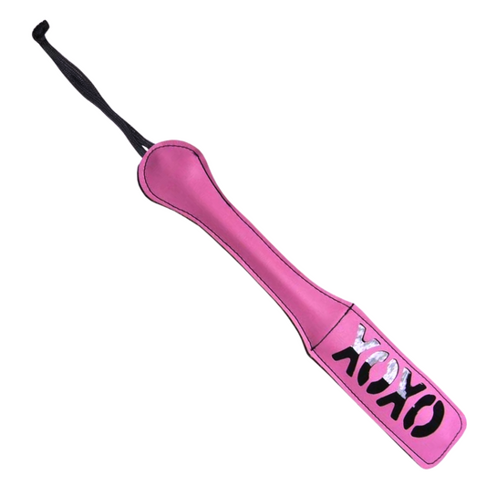 Blush XOXO Paddle: Vegan-friendly vinyl paddle with XOXO cutout impressions and dual-sided design for playful and stylish BDSM fun.