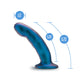 A shimmering blue strap-on-compatible dildo with a curved design, made from body-safe silicone for intermediate-level play.

Keywords: Temptasia Surrender Peg, intermediate pegging dildo, harness compatible, Puria silicone dildo, UltraSilk finish, G-spot stimulation, strap-on play, blue dildo, body-safe silicone, vaginal and anal dildo, intermediate-level toy