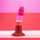 Lesbian pride-colored silicone dildo with a petite design, straight shaft, and suction base, made from smooth Purio™ silicone. Keywords: lesbian pride dildo, Avant dildo, petite dildo, beginner-friendly dildo, suction cup dildo, harness-compatible dildo, body-safe silicone dildo, colorful pride dildo, Purio silicone, artisan-crafted dildo.
