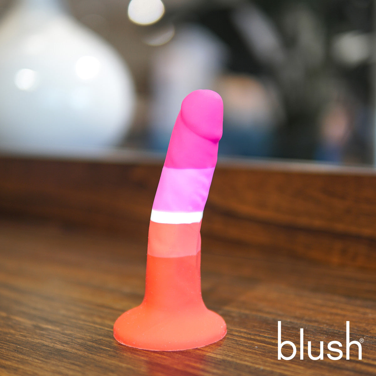 Lesbian pride-colored silicone dildo with a petite design, straight shaft, and suction base, made from smooth Purio™ silicone. Keywords: lesbian pride dildo, Avant dildo, petite dildo, beginner-friendly dildo, suction cup dildo, harness-compatible dildo, body-safe silicone dildo, colorful pride dildo, Purio silicone, artisan-crafted dildo.
