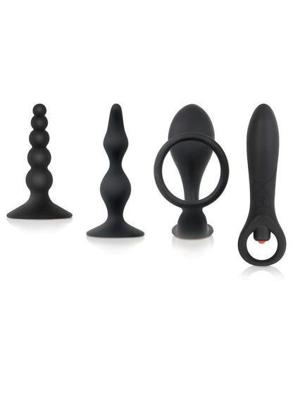 Zero Tolerance Intro to Prostate Silicone with Movie and Lube - Black - 4 Piece Kit A set of four black silicone prostate massagers, including a vibrating model, a cock ring with an attached plug, a beaded plug, and a classic tapered plug with a suction cup base, displayed side by side.