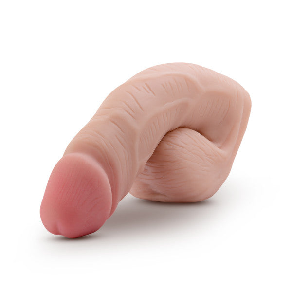 Product image. Packer shown out of box. Light skin tone with pink fish tip. Circumcised. Flaccid.