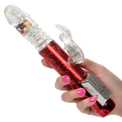 Red metallic rabbit vibrator with thrusting shaft, gum ball accents, and 10 vibration functions featuring a flickering rabbit teaser.
Keywords: thrusting rabbit vibrator, 4-speed vibrator, 10-function rabbit vibe, waterproof thrusting vibrator, Naughty Bits collection, metallic red rabbit vibrator, flickering bunny vibrator, synchronized rotating bead vibrator, customizable rabbit vibrator.